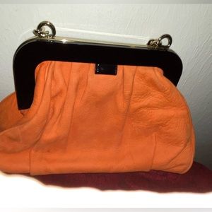 Kate Spade Orange suede handbag. Black frame signature bow.